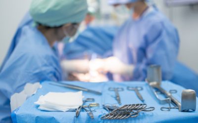 photo of surgeons performing surgery with medical instruments in the foreground